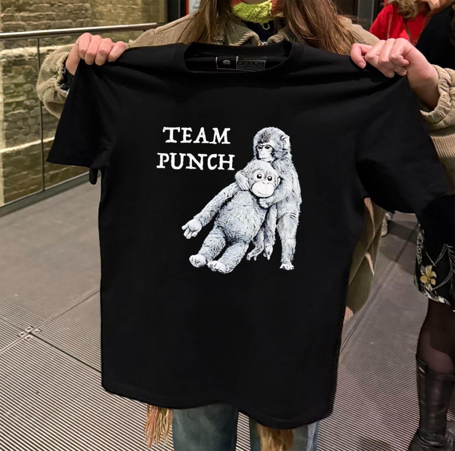Team Punch monkey holding orange stuffed animal friend shirt