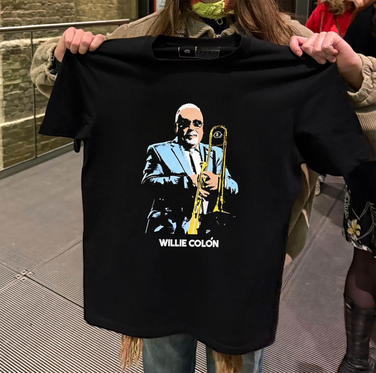 Willie Colón salsa musician playing trombone shirt